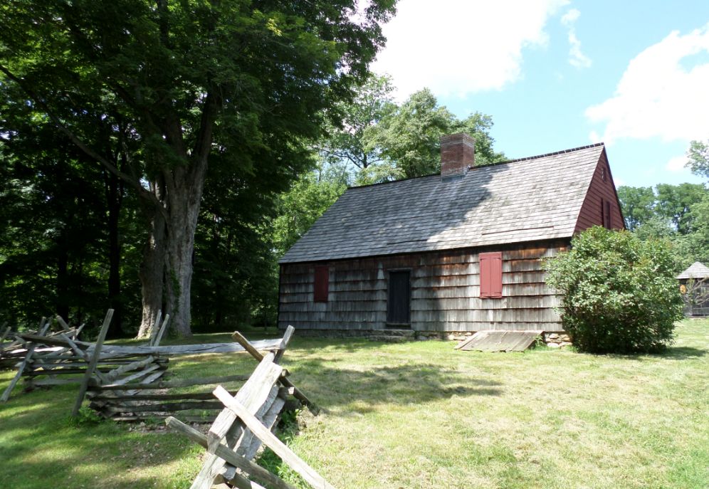 an image of a hut in the middle of a beautiful green field